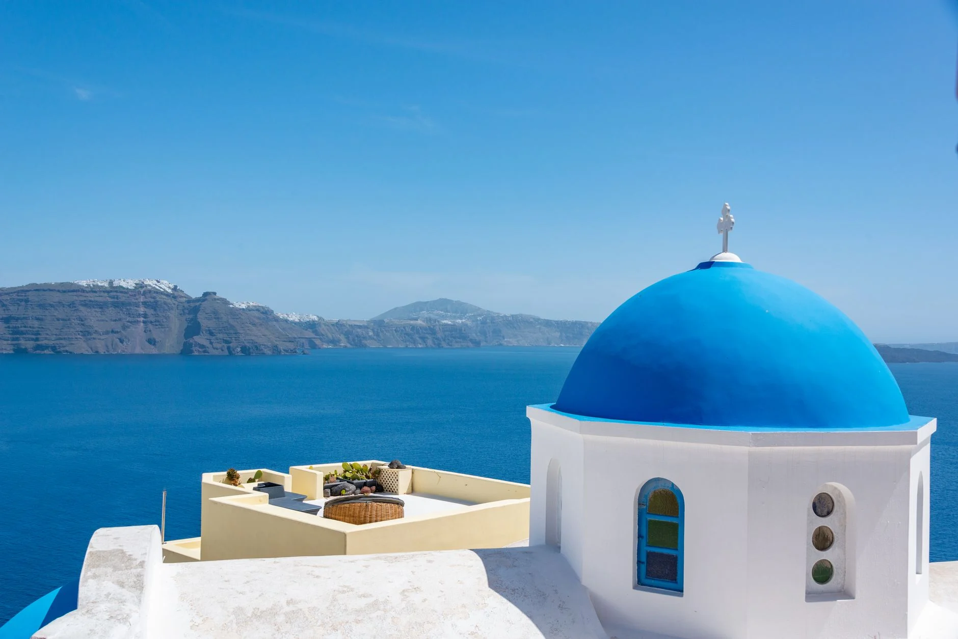 A blue-domed church above the caldera on Santorini