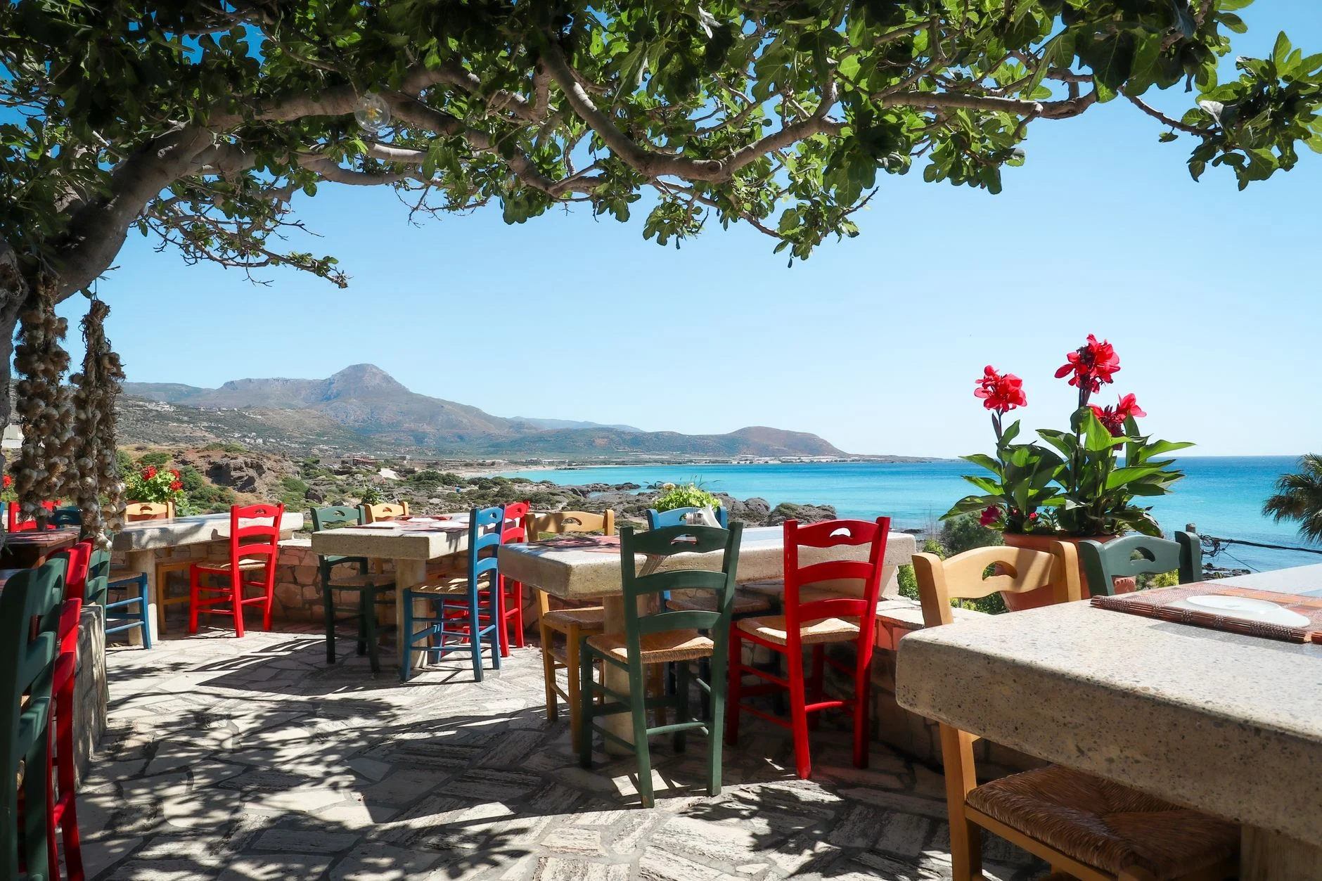 A Greek taverna table set beside the sea