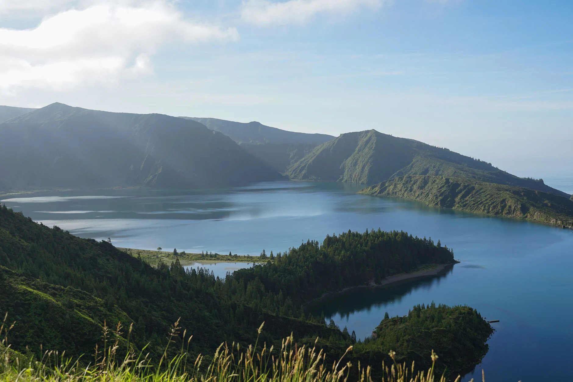 A green crater lake on São Miguel, Azores, under a blue sky