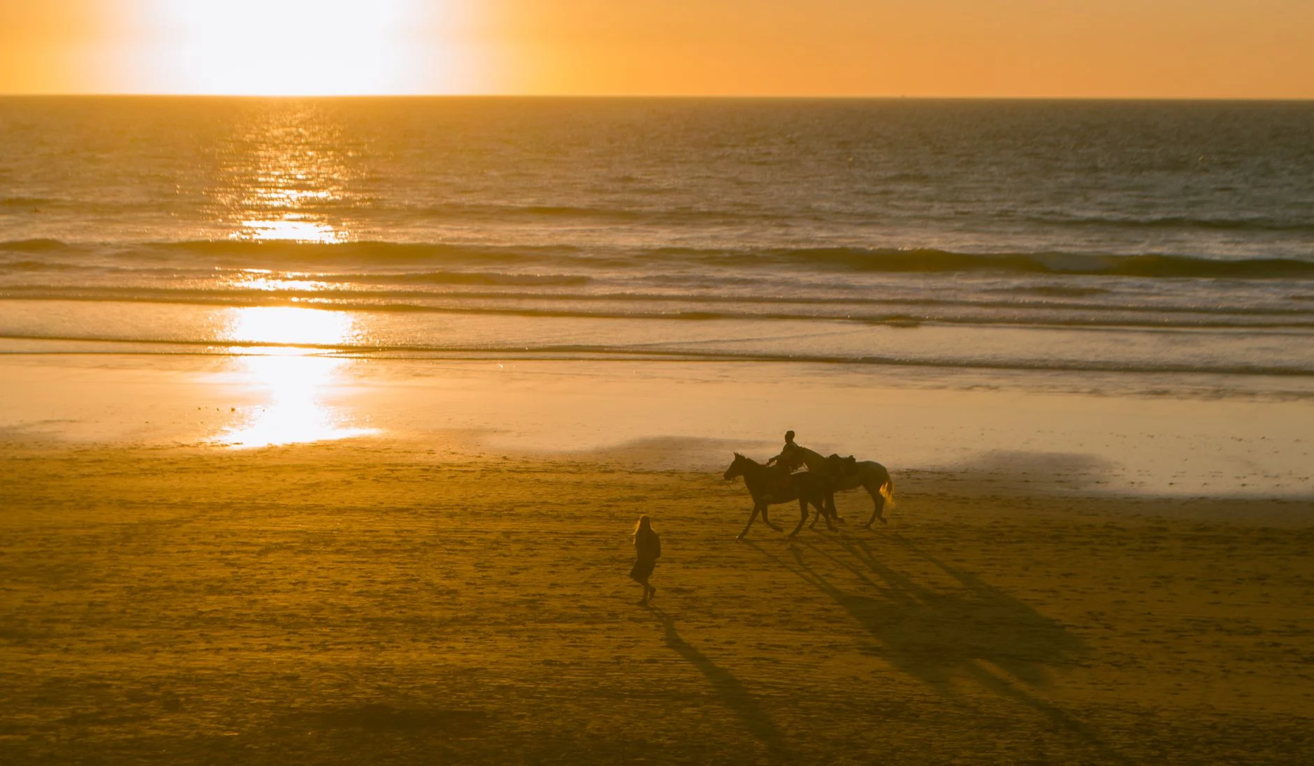 A golden beach on Morocco's Atlantic coast in warm light