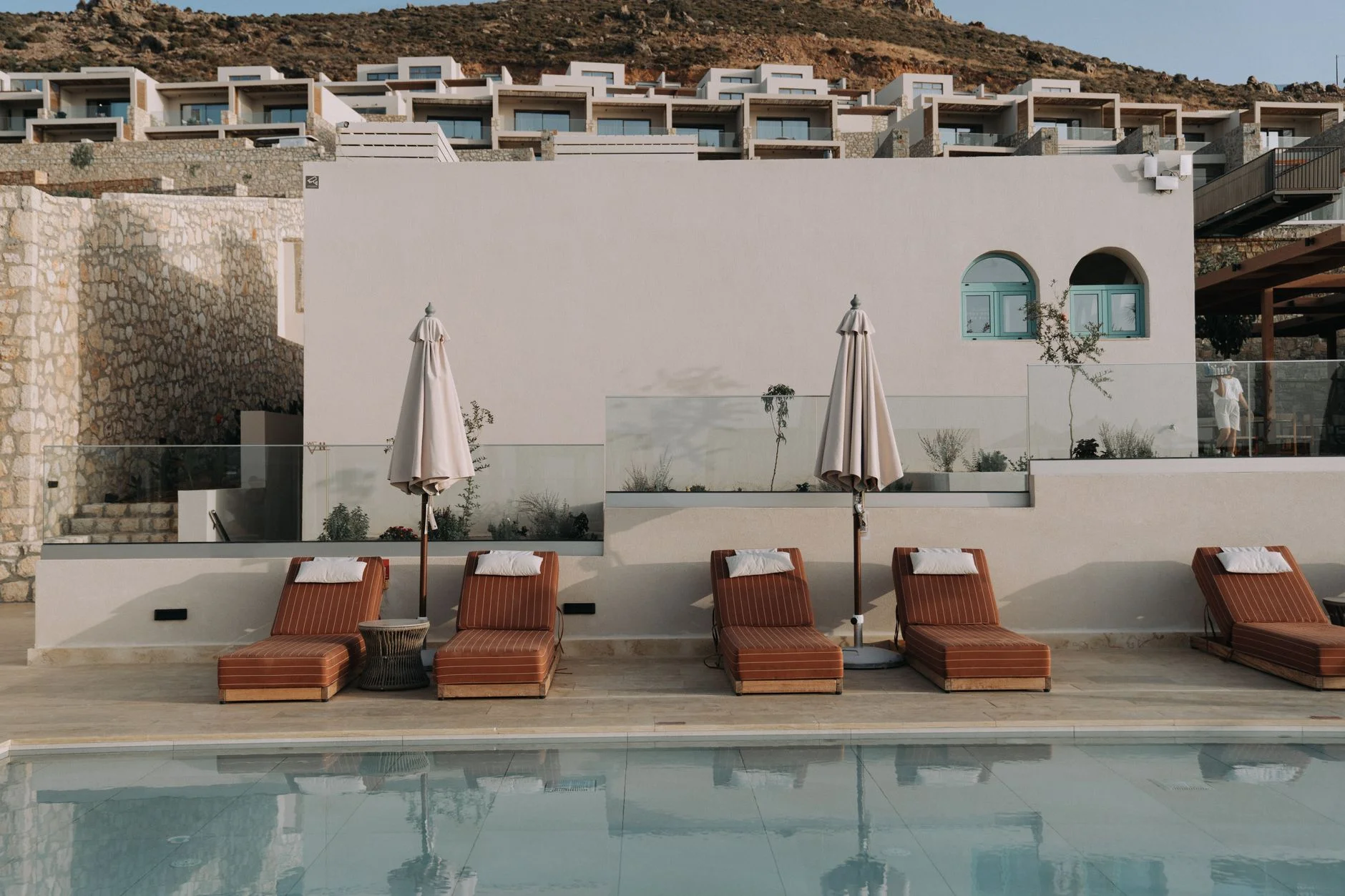 A quiet boutique hotel terrace with pool and natural materials