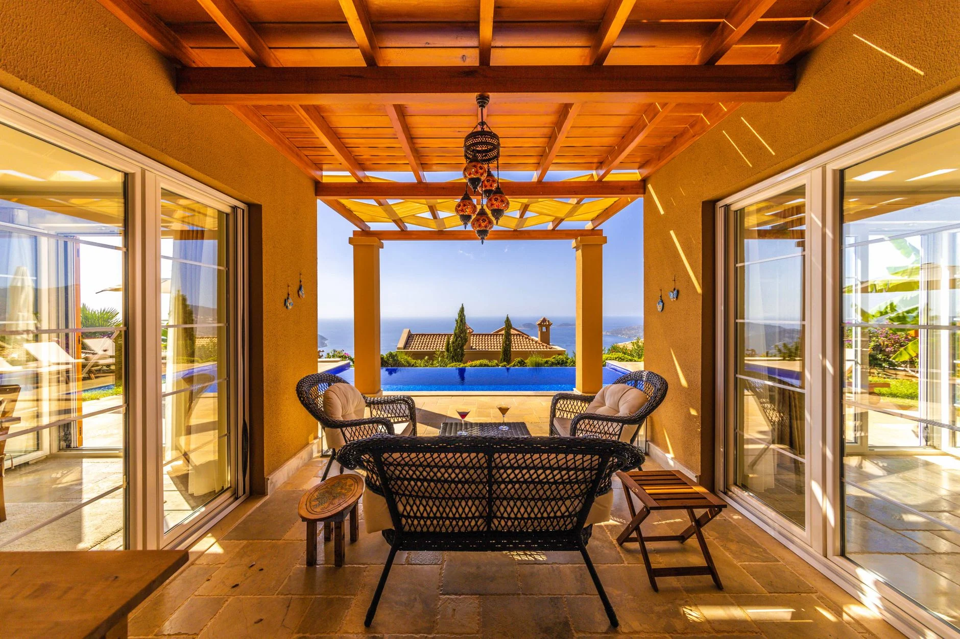 A refined villa terrace overlooking summer water